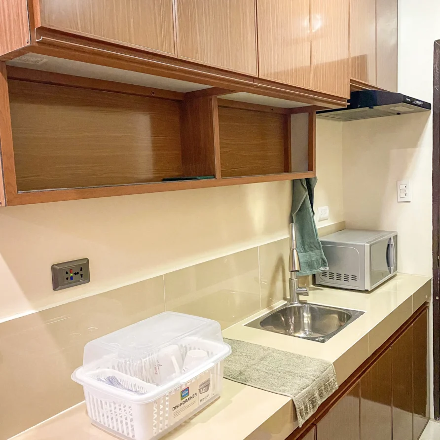 Deluxe Studio Room with queen bed, bunk bed, Smart TV, and kitchenette at Vera Cruz Apartelle in Tagbilaran City, Bohol