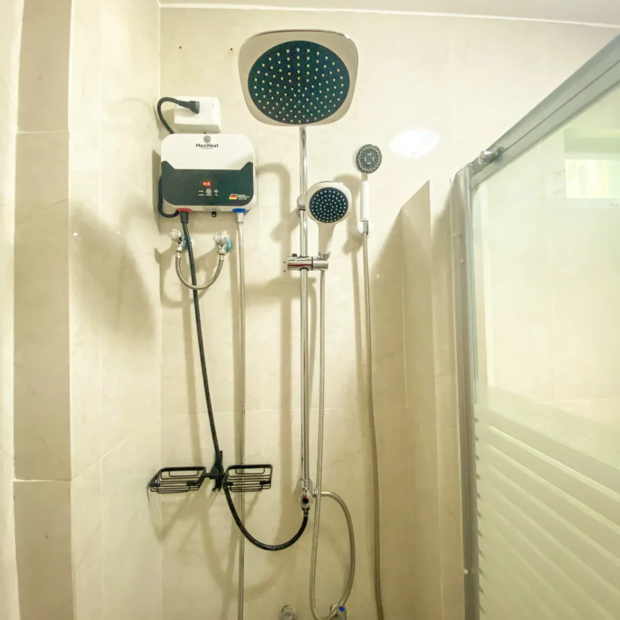 Deluxe Studio Room with queen bed, bunk bed, Smart TV, and kitchenette at Vera Cruz Apartelle in Tagbilaran City, Bohol