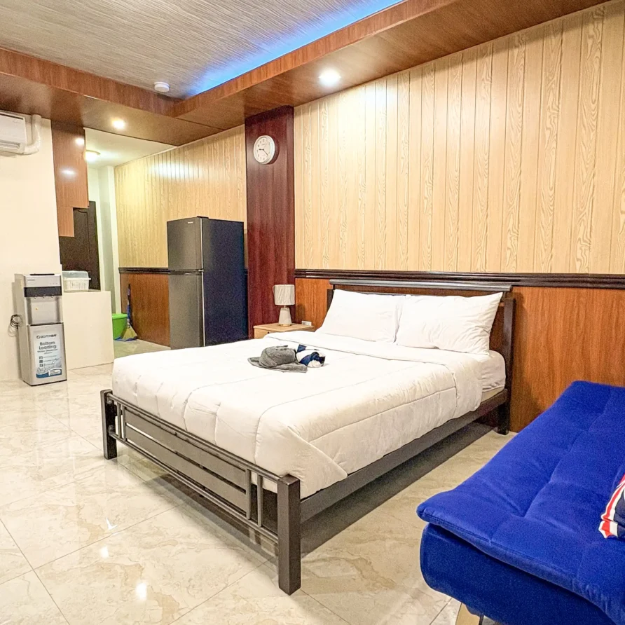 Deluxe Studio Room with queen bed, bunk bed, Smart TV, and kitchenette at Vera Cruz Apartelle in Tagbilaran City, Bohol
