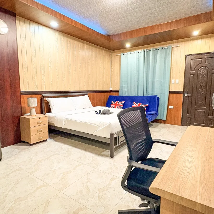 Deluxe Studio Room with queen bed, bunk bed, Smart TV, and kitchenette at Vera Cruz Apartelle in Tagbilaran City, Bohol