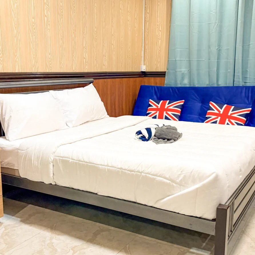 Deluxe Studio Room with queen bed, bunk bed, Smart TV, and kitchenette at Vera Cruz Apartelle in Tagbilaran City, Bohol