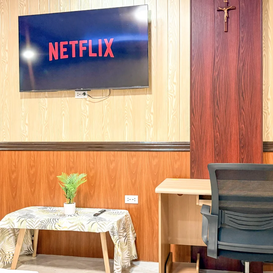 Deluxe Studio Room with queen bed, bunk bed, Smart TV, and kitchenette at Vera Cruz Apartelle in Tagbilaran City, Bohol