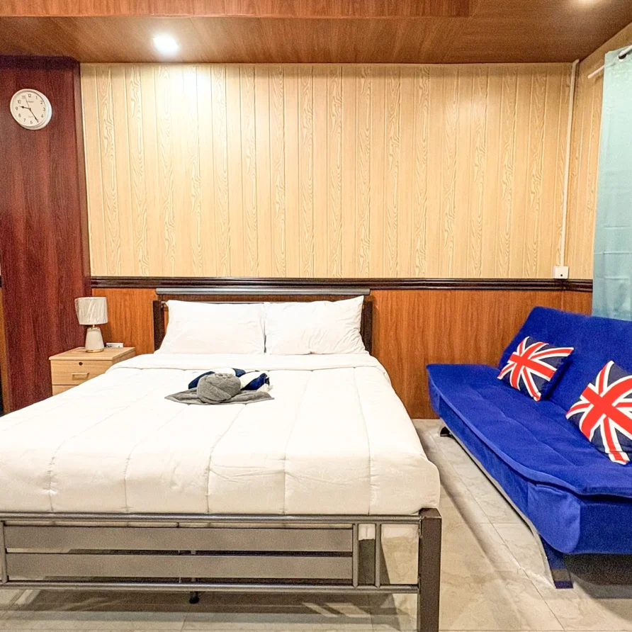 Deluxe Studio Room with queen bed, bunk bed, Smart TV, and kitchenette at Vera Cruz Apartelle in Tagbilaran City, Bohol